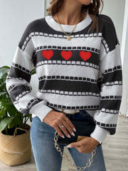 Black and white striped knit sweater with embroidered red hearts, crew neck, long sleeves.
