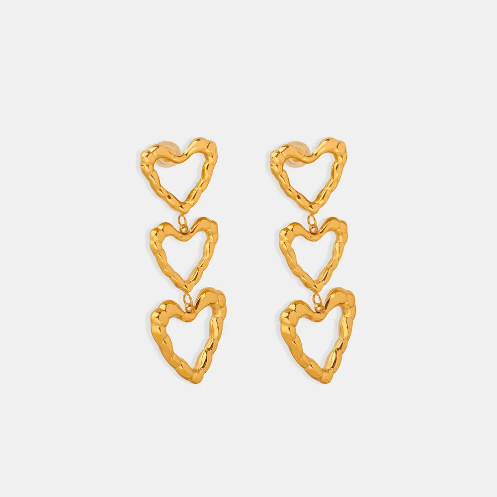 Gold triple heart drop earrings with textured finish