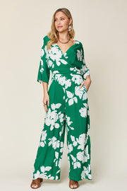 Green floral kimono jumpsuit with wide legs and a wrap V-neckline.