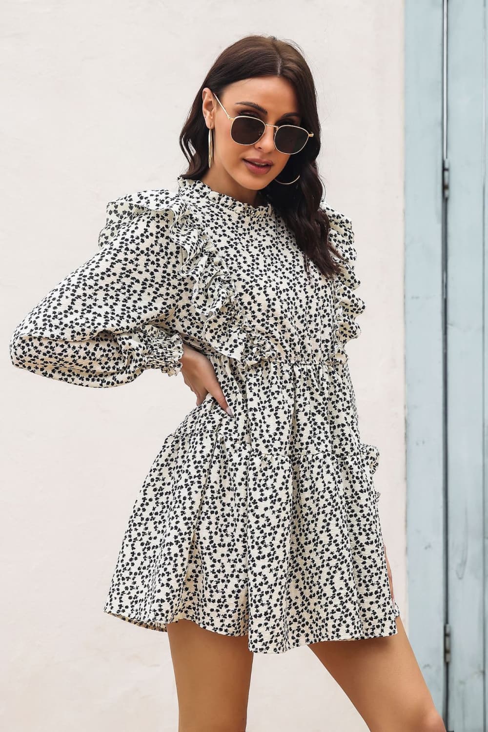 Cream dot print dress with ruffle trim, high neck, and long puff sleeves.
