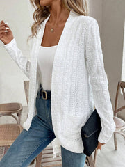 White open-weave embroidered cardigan with pockets and fringe detail.