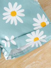 Baby overalls in picture color with a daisy print and cuffed hem.