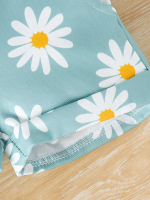Baby overalls in picture color with a daisy print and cuffed hem.