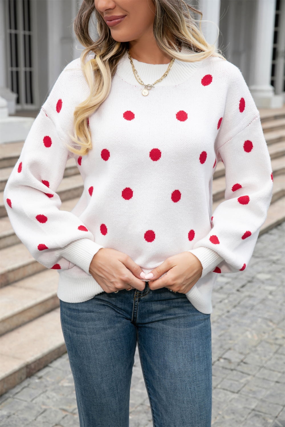 White knit sweater with red polka dots and balloon sleeves, crew neck, ribbed cuffs and hem.