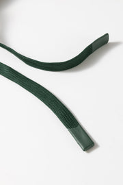 Dark green drawstring with leather tips on a romper.