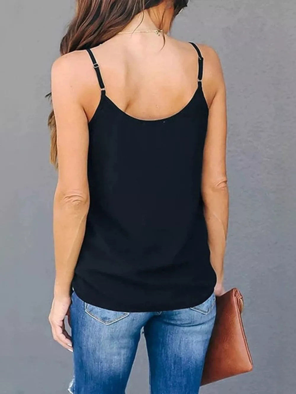 Black cami top with adjustable straps and V-neck detail.