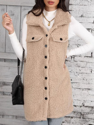Tan sherpa utility vest with collar, button front, and chest pockets.