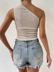 Asymmetrical waffle knit tank top in apricot, one-shoulder design.