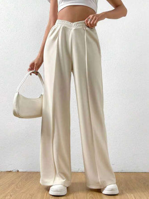 Cream V-waistline palazzo sweatpants with center seams and wide legs.