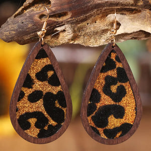 Wood-framed teardrop glitter earrings with leopard print detail.