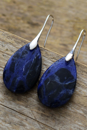 Silver dangle earrings with teardrop sapphire stones and gold accents