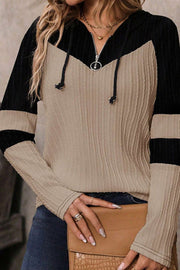 Colorblock ribbed zip-neck hoodie in mocha and black with drawstring hood and silver zipper detail.