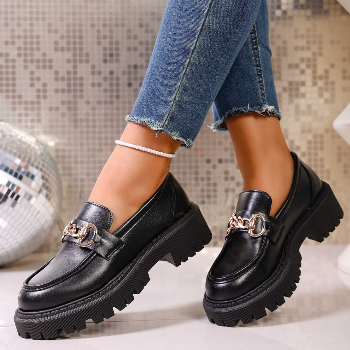 Chunky lug sole loafers in gloss black with gold chain detail and thick platform sole.