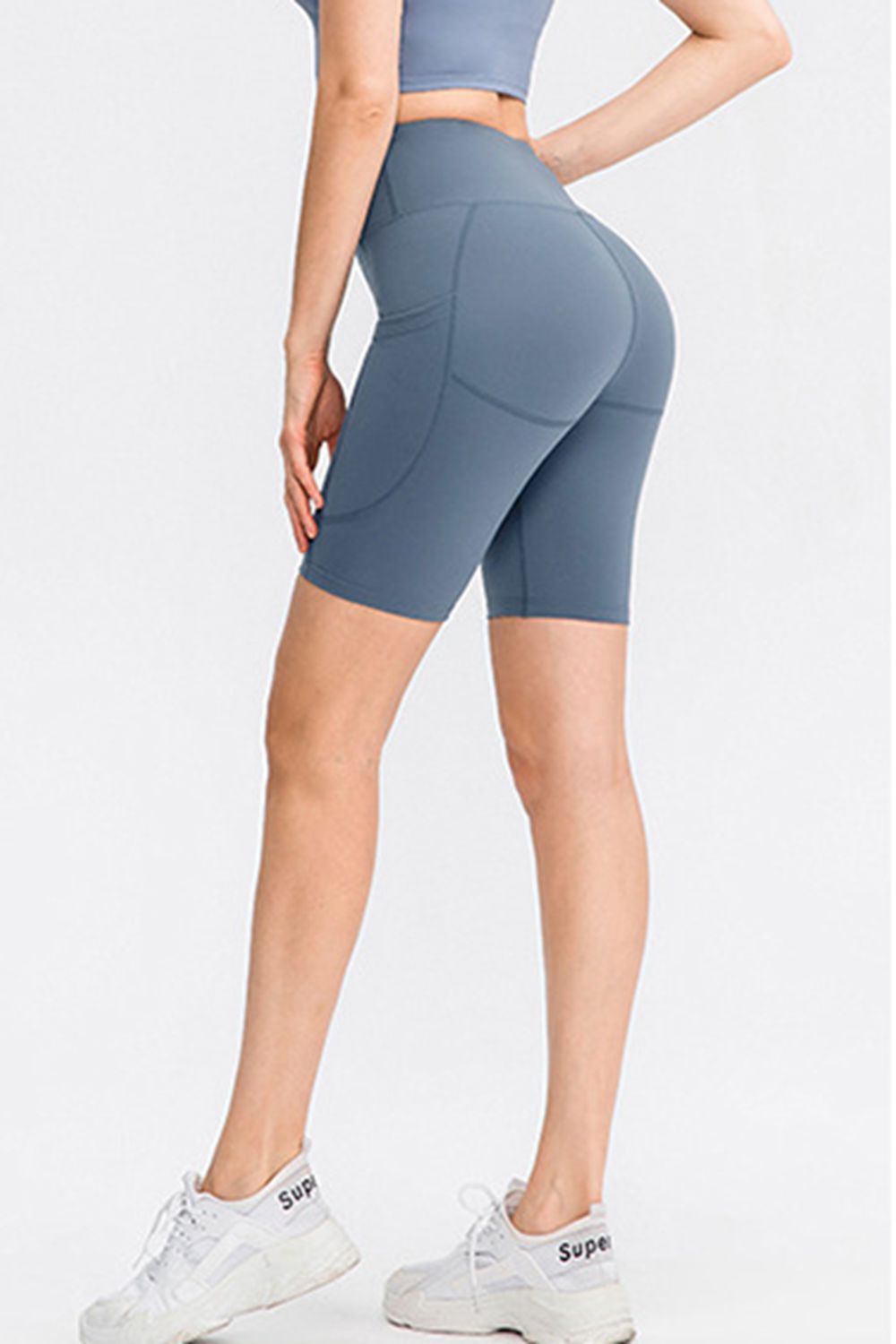 Light blue sculpting pocketed cycling shorts with a high waist.