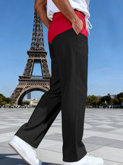 Men's black sweatpants with red two-tone waistband and drawstring, relaxed fit.