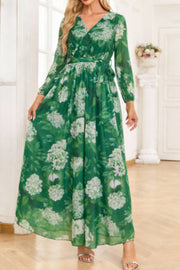 Green floral print maxi dress with V-neck, long sleeves, and tied waist.