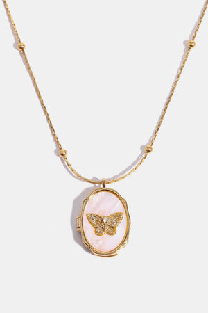 Gold locket necklace with pink mother of pearl inlay and a detailed butterfly charm.