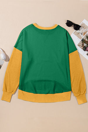 Green and yellow contrast crewneck sweatshirt with long sleeves and ribbed cuffs and hem.