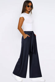Dark Navy wide-leg flow pants with self-tie waist and pockets.