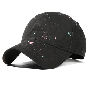 Black cotton baseball cap with pink and blue splatter paint detail