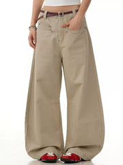 Khaki wide-leg sweatpants with pockets and a belt, styled with red sneakers.