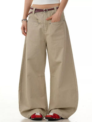 Khaki wide-leg sweatpants with pockets and a belt, styled with red sneakers.