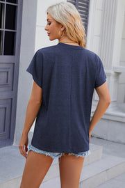 Dolman sleeve slouchy v-neck top in dark blue, casual fit, styled with denim shorts.
