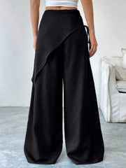 Black maternity wide-leg trousers with a high waist and wrap-style overlay.