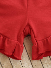 Red cotton baby shorts with ruffled hem detail