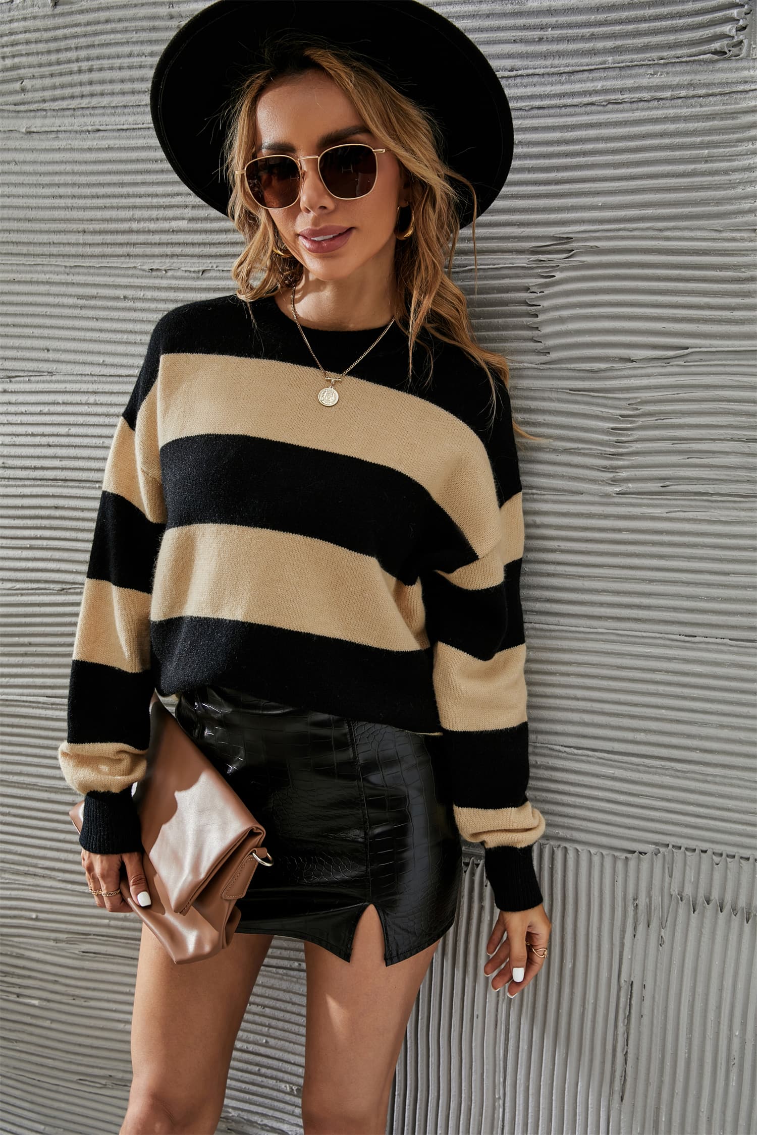 Bold stripe relaxed knit jumper in apricot and black acrylic blend with crew neck and long sleeves.