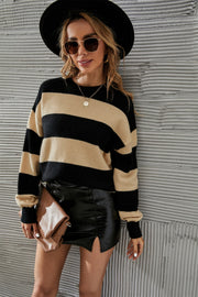 Bold stripe relaxed knit jumper in apricot and black acrylic blend with crew neck and long sleeves.