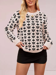 Cream and black argyle heart knit sweater with crew neck and long sleeves.