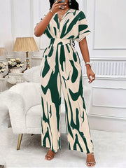 Green and cream abstract print wide-leg romper with V-neck and short sleeves.