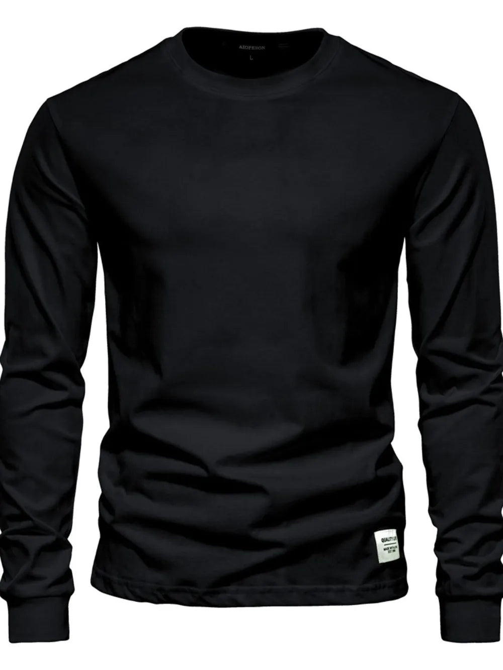 Black crewneck long sleeve t-shirt with a small white tag detail on the hem.