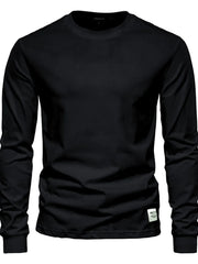 Black crewneck long sleeve t-shirt with a small white tag detail on the hem.