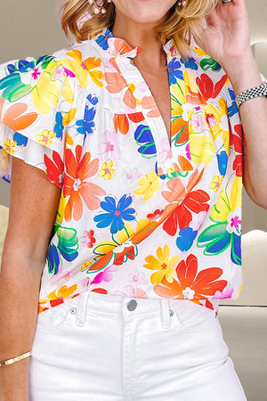 Vibrant floral ruffle-collar blouse with short sleeves and a V-neck.
