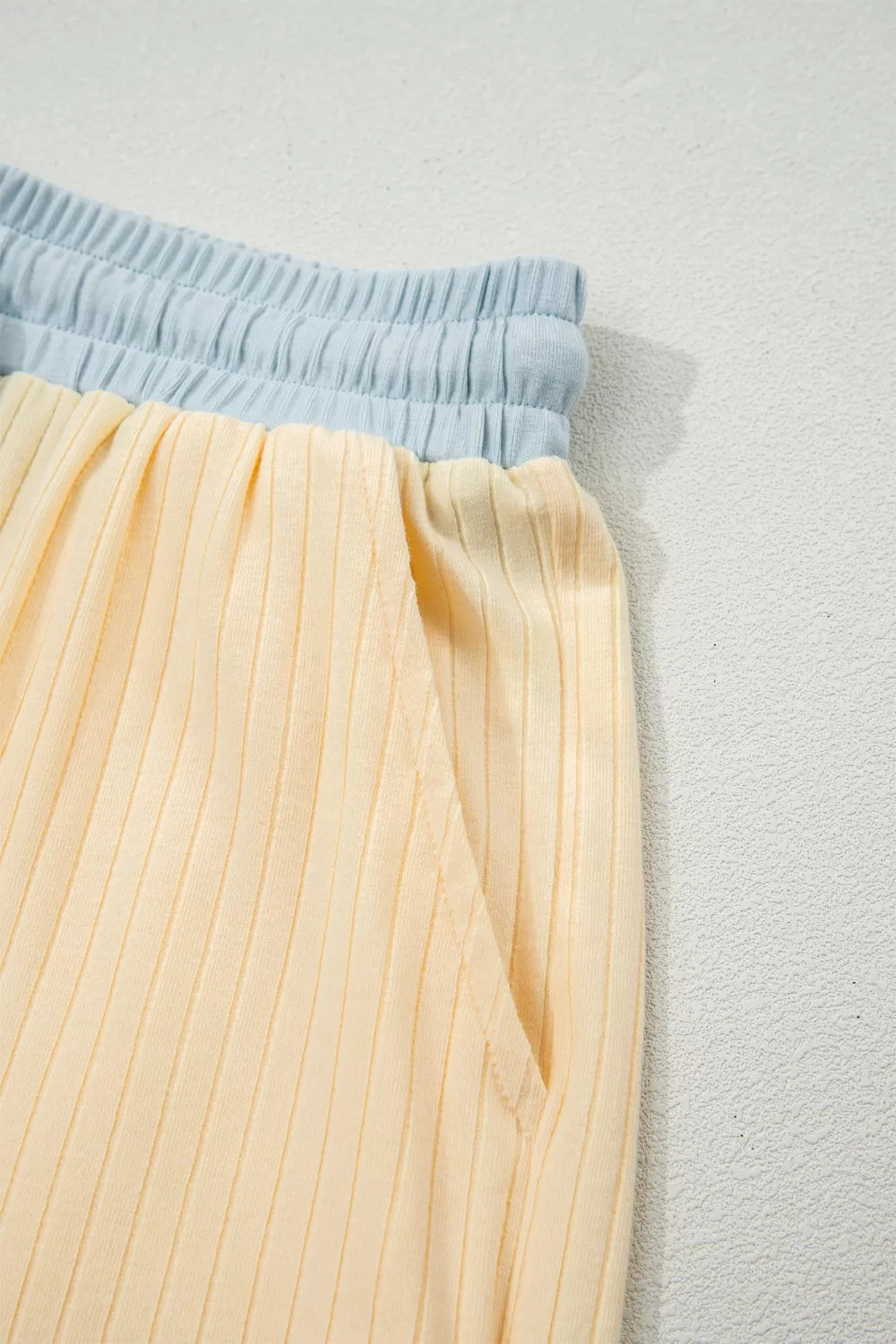 Color block ribbed two-piece set with elastic waistband and pocket detail.