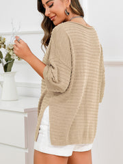 Tan knit sweater with boat neck, textured pattern, and slit hem detail.