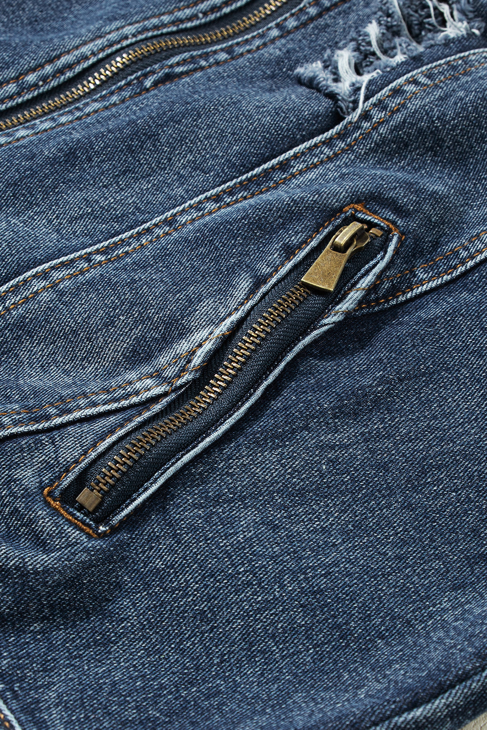 Dark blue denim jacket with distressed details and a zippered pocket.
