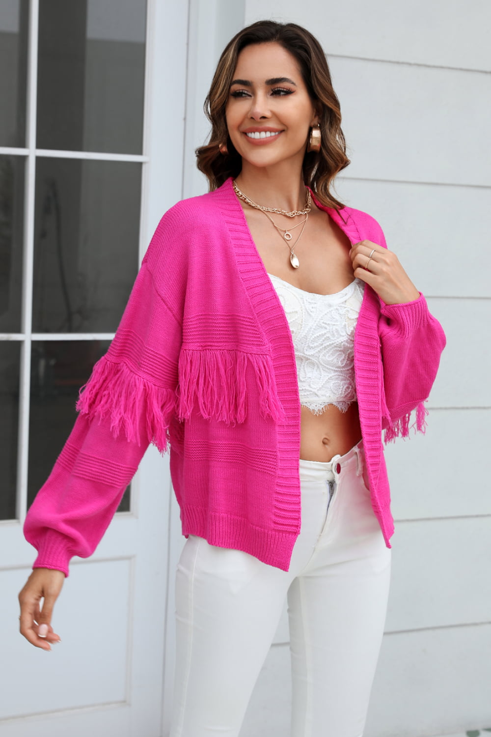Hot Pink acrylic cardigan with fringe sleeves and textured knit detail.