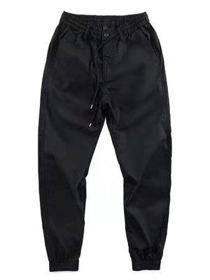 Black relaxed fit joggers with drawstring and elastic cuffs.