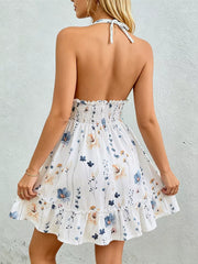 Floral print halter neck mini dress with smocked waist and ruffled hem.