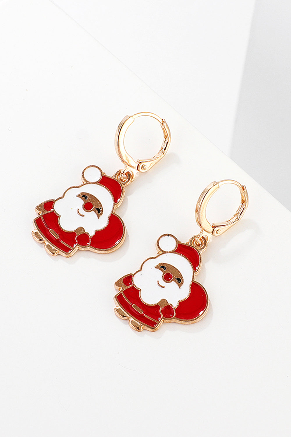 Festive Santa charm hoop earrings in red and white enamel with gold-tone alloy.