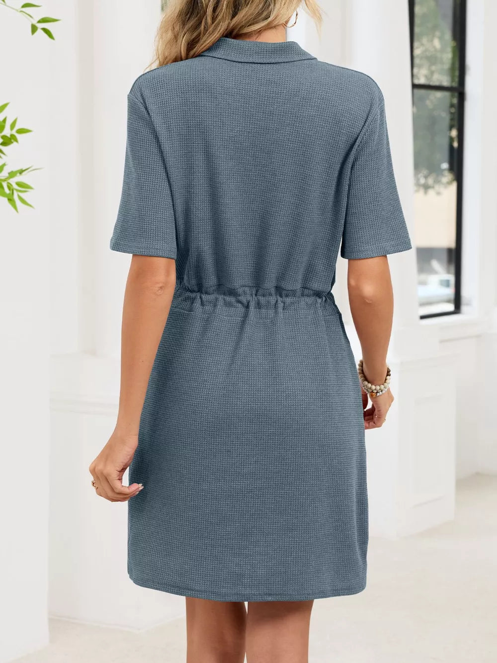 Blue gray textured polo dress with short sleeves and adjustable drawstring waist.