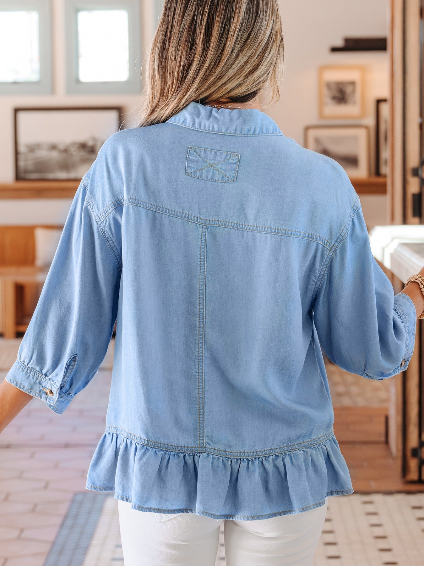 Light blue chambray button-down shirt with ruffled hem and 3/4 sleeves.