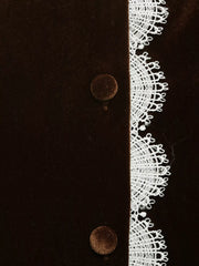 Brown velvet blouse with white lace trim and button detail.