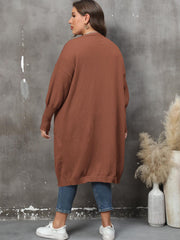 Brown oversized knit duster cardigan with patch pockets and long sleeves.