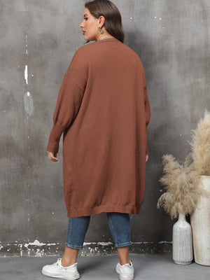 Brown oversized knit duster cardigan with patch pockets and long sleeves.