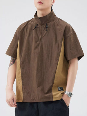 Brown and tan colorblock activewear pullover top with quarter zip and short sleeves.