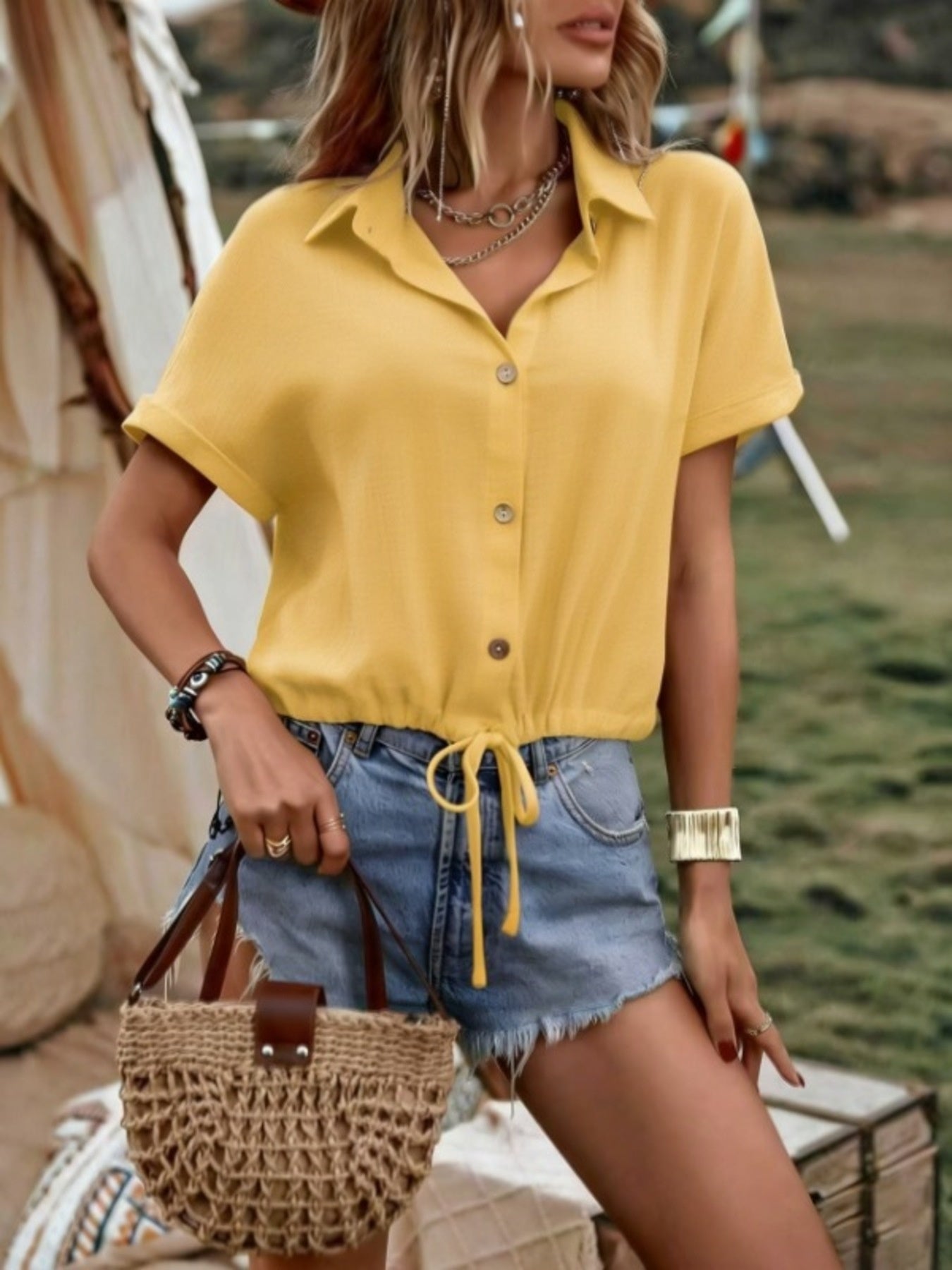Yellow button-down shirt with drawstring hem, short sleeves, and a collared neckline.